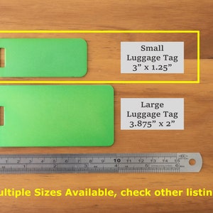 May include: Two green luggage tags, one small and one large, on a wooden surface. The small tag measures 3 inches by 1.25 inches. The large tag measures 3.875 inches by 2 inches. A ruler is below the tags. The text "Multiple Sizes Available, check other listings" is at the bottom of the image.