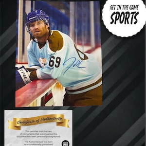 May include: An autographed hockey jersey with the number 69, worn by a player in a blue and brown uniform. The image includes a "Certificate of Authenticity" and the text "GET IN THE GAME SPORTS".