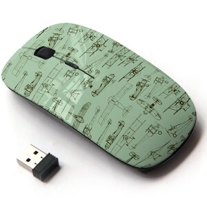 May include: A green wireless computer mouse with a pattern of vintage aeroplane illustrations.