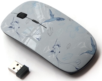 May include: A wireless computer mouse with a light gray background and a blue hummingbird pattern. The mouse has a black scroll wheel and a black USB receiver.