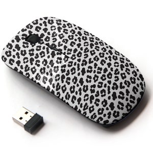 May include: A wireless computer mouse with a black and white leopard print design. The mouse comes with a small USB receiver.
