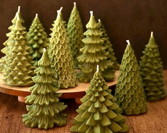 May include: A collection of green pine tree shaped candles. The candles are arranged on a wooden surface.