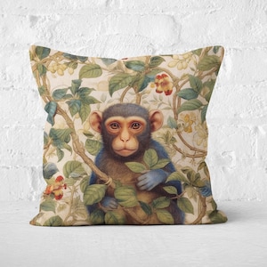 May include: A decorative throw pillow with a vintage illustration of a monkey sitting in a lush green jungle. The monkey has blue fur and is looking directly at the viewer.