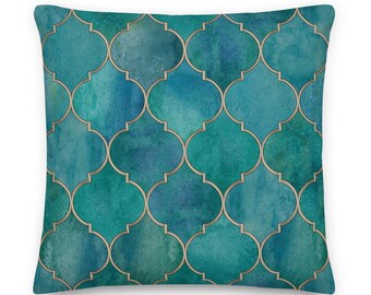 May include: Teal blue throw pillow with a geometric pattern of gold quatrefoil shapes.