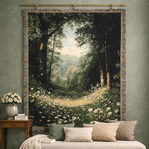 May include: A rectangular woven wall tapestry featuring a forest landscape with tall dark trees, a sunlit clearing, and a foreground filled with white and yellow wildflowers. The tapestry has a fringed border and hangs from a gold metal rod.
