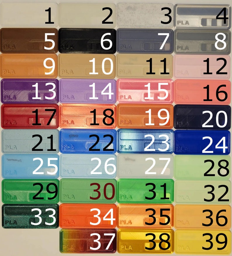 May include: A grid of 39 small plastic squares, each with a different colour and a number from 1 to 39. The squares are arranged in six rows and seven columns. The squares are all the same size and shape. The colours of the squares are a variety of bright colours, including red, orange, yellow, green, blue, purple, and brown.