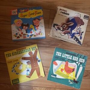 May include: Four vintage children's record albums. Titles include "Sugar Jump Town", "Peter Rabbit and other tales", "The Gingerbread Boy", and "The Little Red Hen". Each album features colorful illustrations and the Decca Records logo.