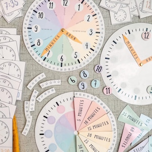 May include: A set of colourful analogue clocks and time telling tools for teaching children about time. The clocks feature pastel colours and numbers, with some clocks having movable hands. There are also cards with different times written on them.