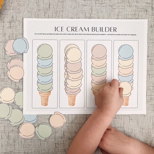 May include: A printable ice cream builder activity for kids. The worksheet features four ice cream cones with different colored scoops. There are also separate cut-out scoops in various colors to match the cones.