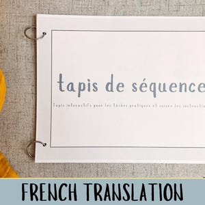 May include: A white card with the text "tapis de séquence" in blue. The text below reads "Tapis interactifs pour les laches pratiques et suivre les instructions". The card has two silver rings at the top.