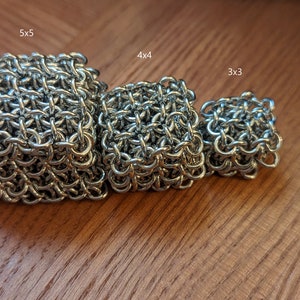 May include: Three silver chainmail cubes of different sizes, labeled 5x5, 4x4, and 3x3.