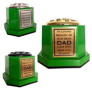 May include: Green hexagonal flower vase with a gold top and a black plaque that reads "In loving memory of our dear Dad Love and miss you always".