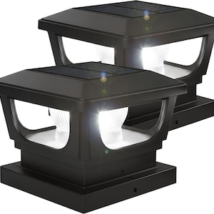 May include: Two black solar-powered post lights with bright white illumination. Each light has a square top with a solar panel and a decorative curved design. The lights are designed for outdoor use and have a modern aesthetic.