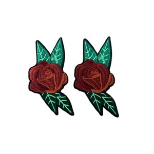 May include: Two embroidered patches featuring a red rose with orange accents and green leaves. The patches are designed with detailed stitching and are set against a white background. These patches are suitable for clothing or craft projects.