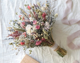 May include: A dried flower bouquet with pink, white, and lavender flowers, tied with a burlap ribbon and lace.