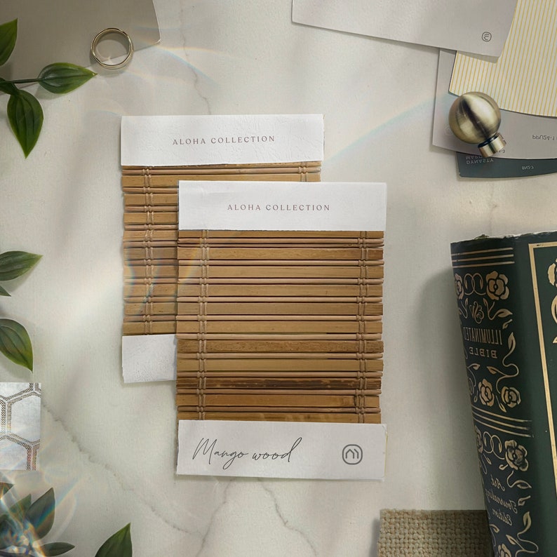 May include: Two samples of Mango Wood from the Aloha Collection. The samples are made of natural wood with a woven pattern. The text "Mango Wood" is printed on the bottom sample.