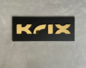 May include: A black rectangular sign with the word "KFIX" in gold letters.