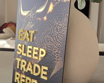 May include: A black and gold motivational sign with a bull silhouette and the text "Eat Sleep Trade Repeat".