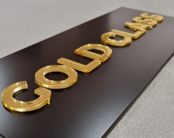 May include: Gold letters spelling "GOLD CLASS" on a black background.
