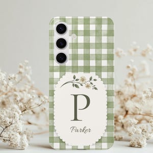 May include: A smartphone case featuring a sage green and white gingham pattern. Centered is a scalloped cream-coloured label with a floral sprig, the large capital letter P, and the name Parker written in a cursive script font below the letter.