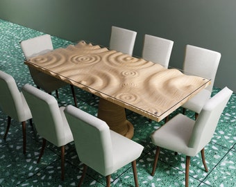 May include: A modern dining table with a unique, carved wooden surface, resembling water ripples, topped with a glass sheet. Eight white upholstered chairs with wooden legs surround the table. The table is approximately 72 inches long.