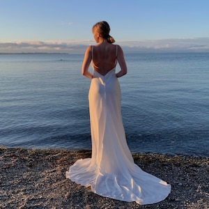 Simple wedding slip dress with open back in ivory. Open back satin slip dress for reception with cowl neck. Wedding dress with a train.