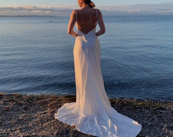 Simple wedding slip dress with open back in ivory. Open back satin slip dress for reception with cowl neck. Wedding dress with a train.