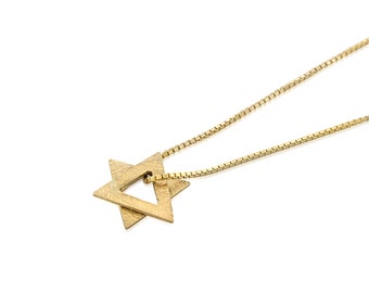 May include: A gold chain necklace with a textured, star of David pendant.