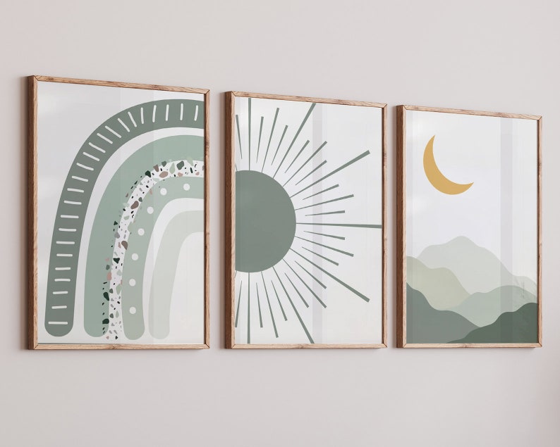 May include: Three framed prints with abstract designs in shades of green and yellow. The first print features a green and white rainbow with a speckled texture. The second print features a green sun with radiating lines. The third print features a yellow crescent moon and green hills.