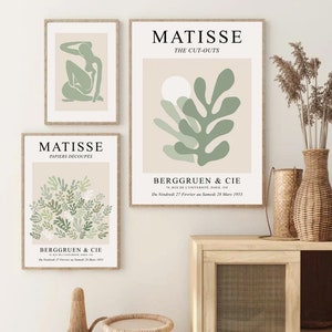 May include: Three minimalist art prints featuring green and white abstract shapes with the text "MATISSE" and "THE CUT-OUTS" on a beige background.