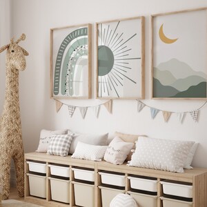 May include: A wooden bench with six storage bins, decorated with three framed prints featuring a rainbow, a sun, and a crescent moon with mountains. The prints have a green, white, and yellow color scheme. The bench is decorated with a string of flags.