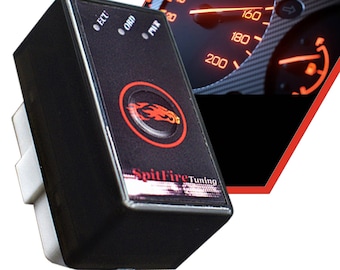 May include: Black electronic device with the text "SpitFire Tuning" and a red logo. The device has three indicator lights and a white connector. A car's speedometer is in the background, showing a speed of 160 km/h.