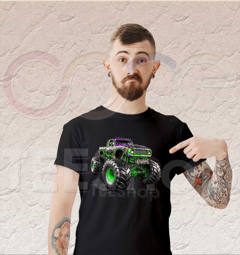 May include: A black t-shirt with a green and purple monster truck graphic. The truck has large tires and is driving on a dirt track. The t-shirt is a great gift for monster truck fans.