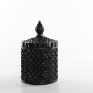 May include: Black glass candle jar with a diamond pattern and a decorative lid. The lid has a pointed top.