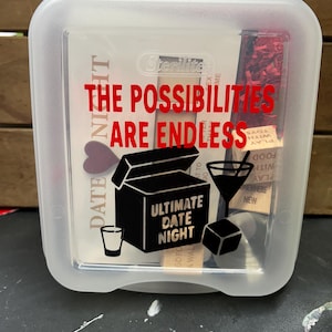 May include: A clear plastic Sterilite container with a lid, featuring red text that reads "THE POSSIBILITIES ARE ENDLESS." The container has a black graphic of a box labeled "ULTIMATE DATE NIGHT" and other date night themed graphics.