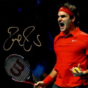 May include: A dynamic image of a tennis player in a red shirt and headband, holding a tennis ball and racket. The player is mid-action, with an open mouth, and a signature in gold. The racket is black and red.