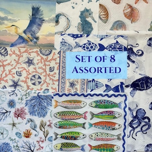 May include: A set of 8 assorted paper napkins featuring various marine life illustrations including a blue heron, seahorses, sea turtles, octopuses, coral, and colorful patterned fish on white backgrounds with the text SET OF 8 ASSORTED.