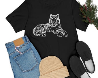 May include: Black t-shirt with a white graphic of a tiger lying down. The tiger has stripes and is looking directly at the viewer.