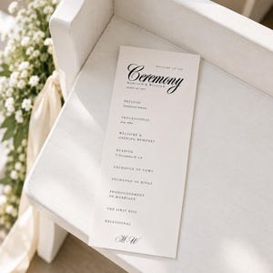 Printable wedding program displayed on a white ceremony pew with soft fabric and natural light, featuring a minimalist 4 x 9 inch wedding ceremony program. Personalize this editable Canva wedding program template with your names, wedding date, ceremony schedule, readings, vows, order of events, and order of service. Perfect for couples searching for wedding programs, a ceremony program, wedding itinerary template, wedding day program, or elegant wedding stationery.