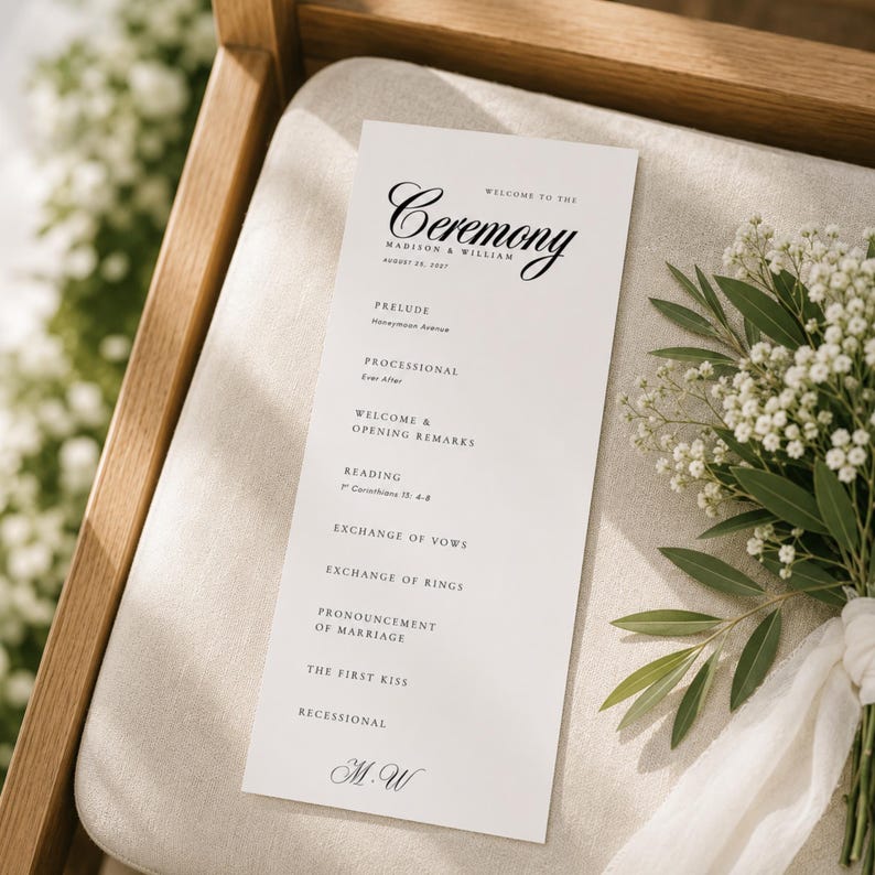 Wedding ceremony program resting on a wooden pew with soft greenery and natural light, showing an elegant 4 x 9 wedding program design for guests to use during the ceremony. This editable wedding program template can be personalized in Canva with your names, date, ceremony program, order of service, readings, vows, and wedding schedule. Ideal for printable wedding programs, a wedding itinerary template, wedding day program, or modern ceremony program.