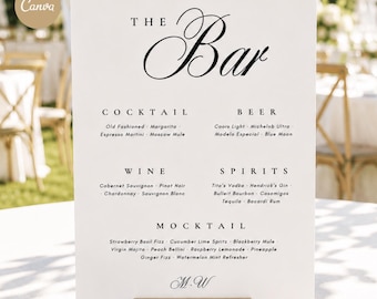 May include: A white rectangular bar menu sign with black text featuring the heading The Bar, followed by sections for Cocktail, Beer, Wine, Spirits, and Mocktail, listing various drink options and the initials M.W. at the bottom, held by a gold stand.