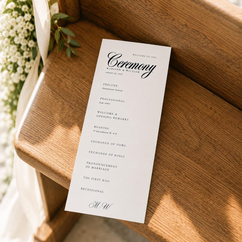 Wedding program displayed on a warm wooden ceremony pew in soft natural sunlight, featuring an elegant 4 x 9 inch wedding program template with minimalist black typography. This editable Canva wedding program can be customized with names, wedding date, ceremony schedule, readings, vows, order of service, and wedding order of events. A beautiful printable wedding program, wedding itinerary template, ceremony program, or wedding day program for an elegant ceremony.