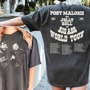 May include: Black t-shirt with a white graphic print of Post Malone and Jelly Roll's "The Big Ass World Tour" with tour dates listed on the back. The front of the shirt features a black and white image of Post Malone and Jelly Roll with their signatures.