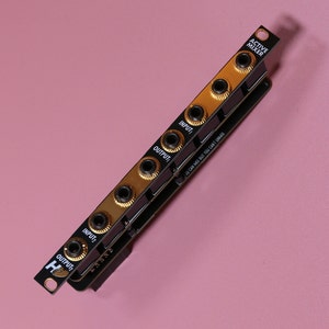 May include: A black and gold active mixer module with the text "ACTIVE MIXER" and "YOU CAN MIX BUT YOU CAN'T UNMIX". The module has multiple input and output jacks.