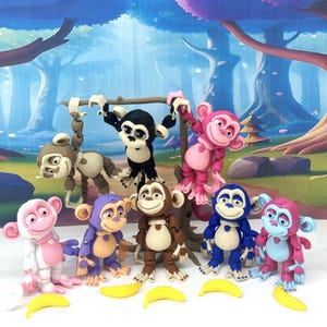 May include: A collection of colorful monkey figurines in various poses, including hanging from a wooden branch. The monkeys are in shades of pink, blue, brown, and black, with yellow banana props. The background features a cartoon forest scene.