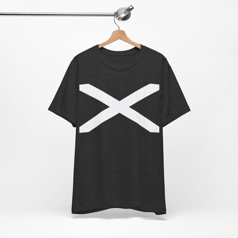 May include: Dark gray t-shirt with a large white X design across the chest. The short-sleeved shirt is hanging on a wooden hanger against a white background. The X design is centered and takes up a significant portion of the shirt's front.
