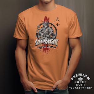 May include: Orange t-shirt featuring a detailed graphic of a samurai warrior with a sword, set against a backdrop of red splatters and Japanese text. The word "SAMURAI" is prominently displayed, with "HONOR BOUND" below.