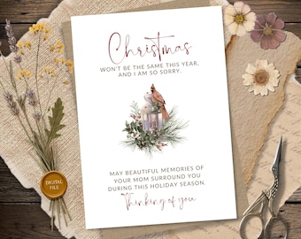 May include: A white greeting card featuring a red cardinal perched on a lantern surrounded by pine branches and berries. The text reads: Christmas won't be the same this year, and I am so sorry. May beautiful memories of your mom surround you during this holiday season. Thinking of you.