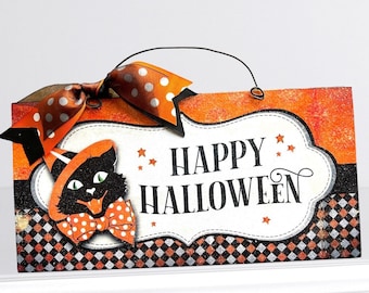 May include: A black and orange Halloween sign with a black cat wearing a witch's hat and a bow tie. The sign says "Happy Halloween" in white letters.