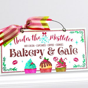Under the Mistletoe Bakery and Cafe sign.